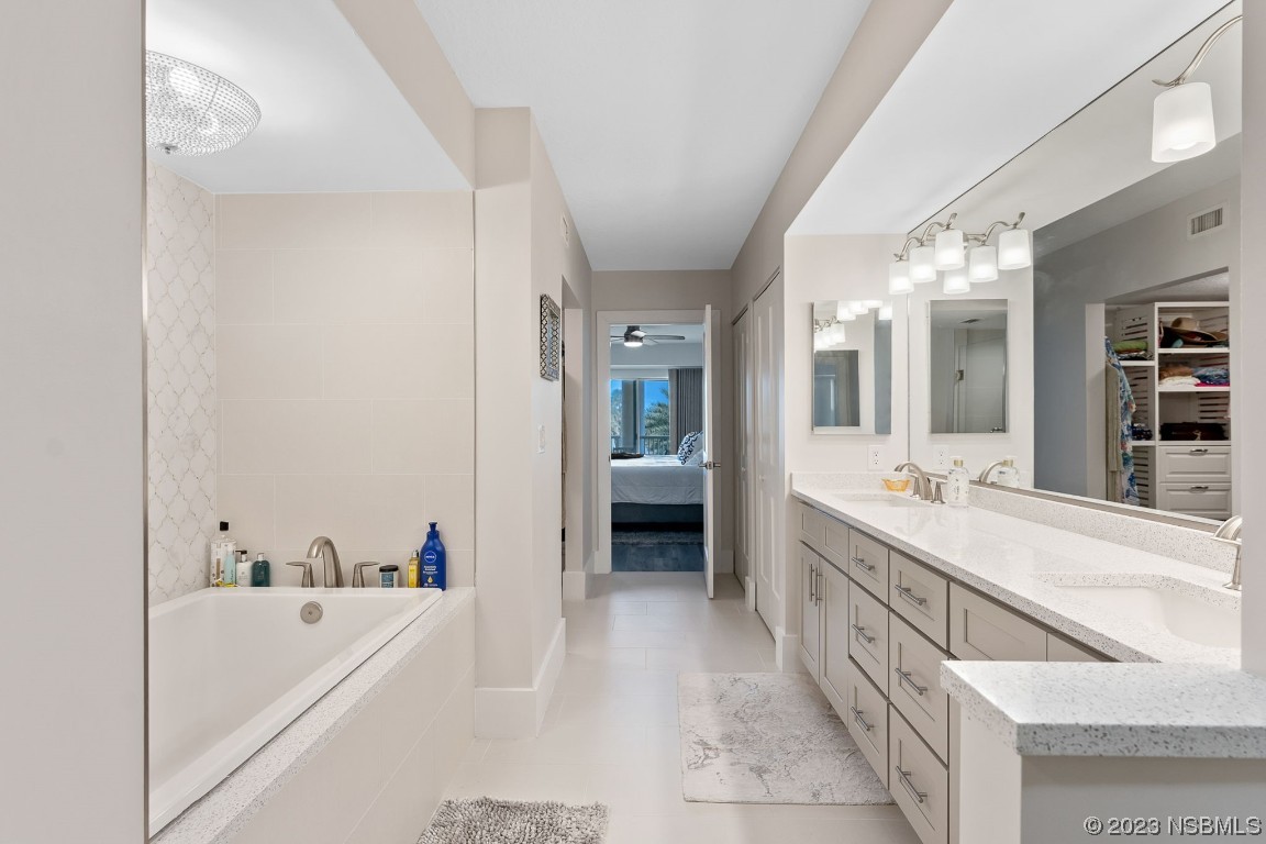 4650 Links Village Drive, Unit A301 Ponce Inlet, FL 32127 - Photo 19 of 54 a large white tub sitting in a bathroom