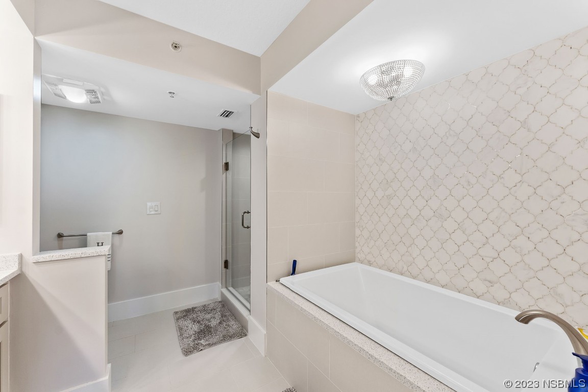 4650 Links Village Drive, Unit A301 Ponce Inlet, FL 32127 - Photo 21 of 54 a bathroom with a bathtub and a sink