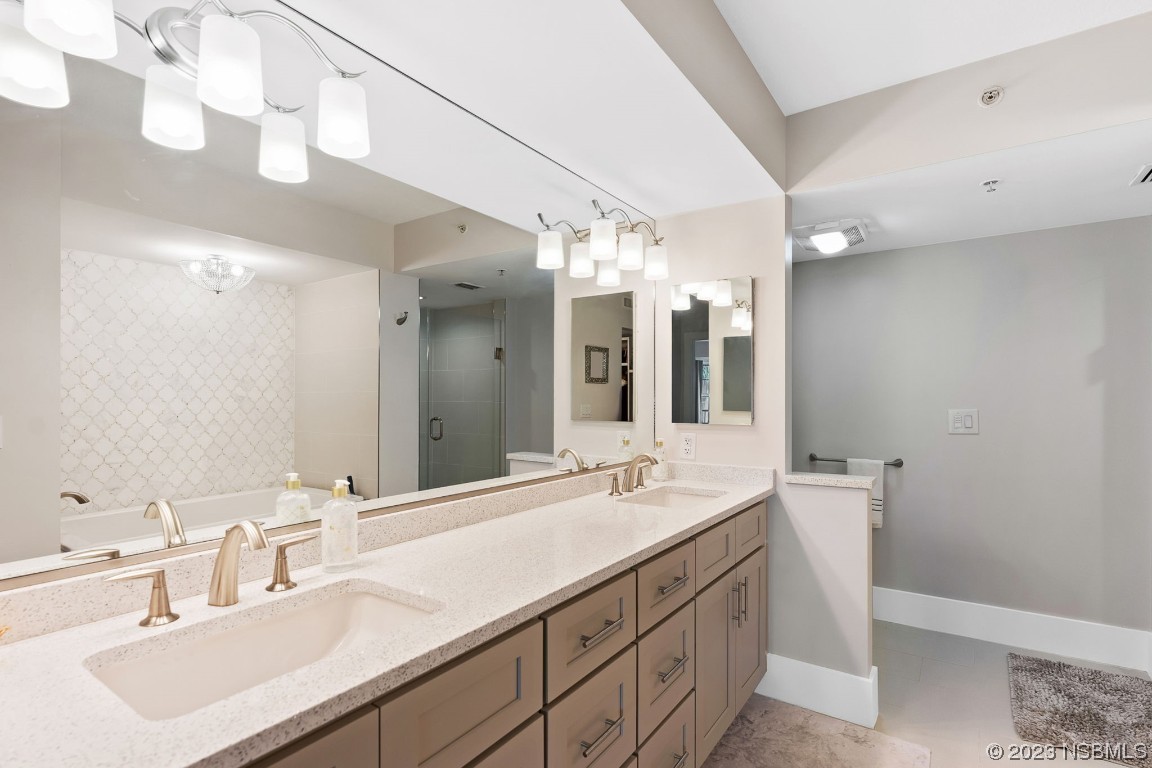 4650 Links Village Drive, Unit A301 Ponce Inlet, FL 32127 - Photo 22 of 54 a bathroom with a sink double vanity and a mirror