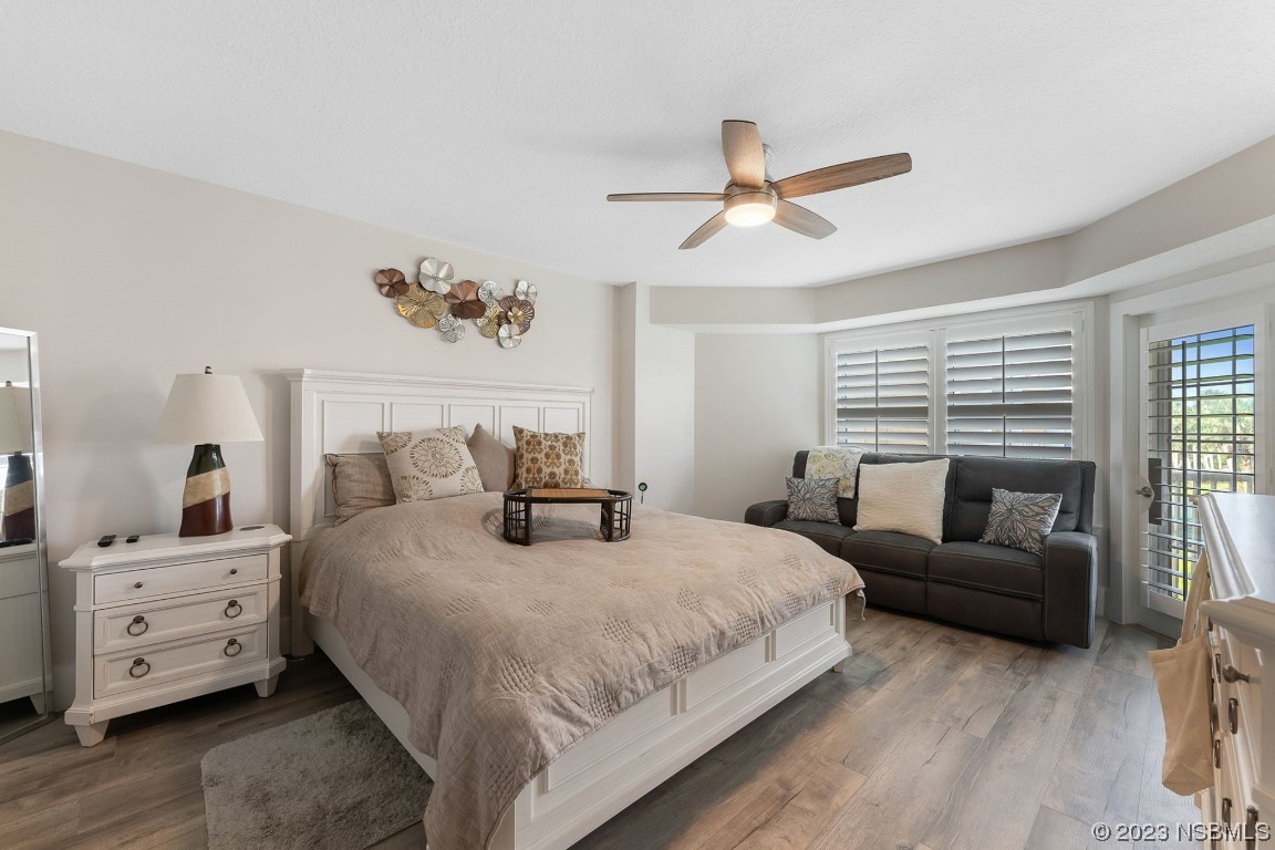 4650 Links Village Drive, Unit A301 Ponce Inlet, FL 32127 - Photo 23 of 54 a bedroom with a bed and a couch