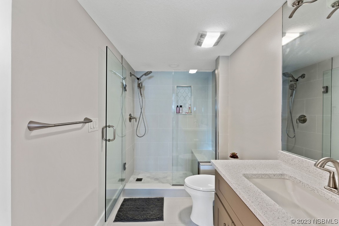 4650 Links Village Drive, Unit A301 Ponce Inlet, FL 32127 - Photo 25 of 54 a bathroom with a sink a toilet and shower