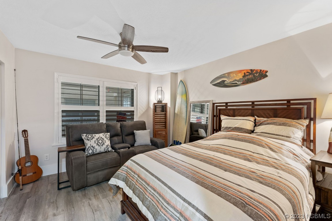4650 Links Village Drive, Unit A301 Ponce Inlet, FL 32127 - Photo 28 of 54 a bedroom with a bed and wooden floor