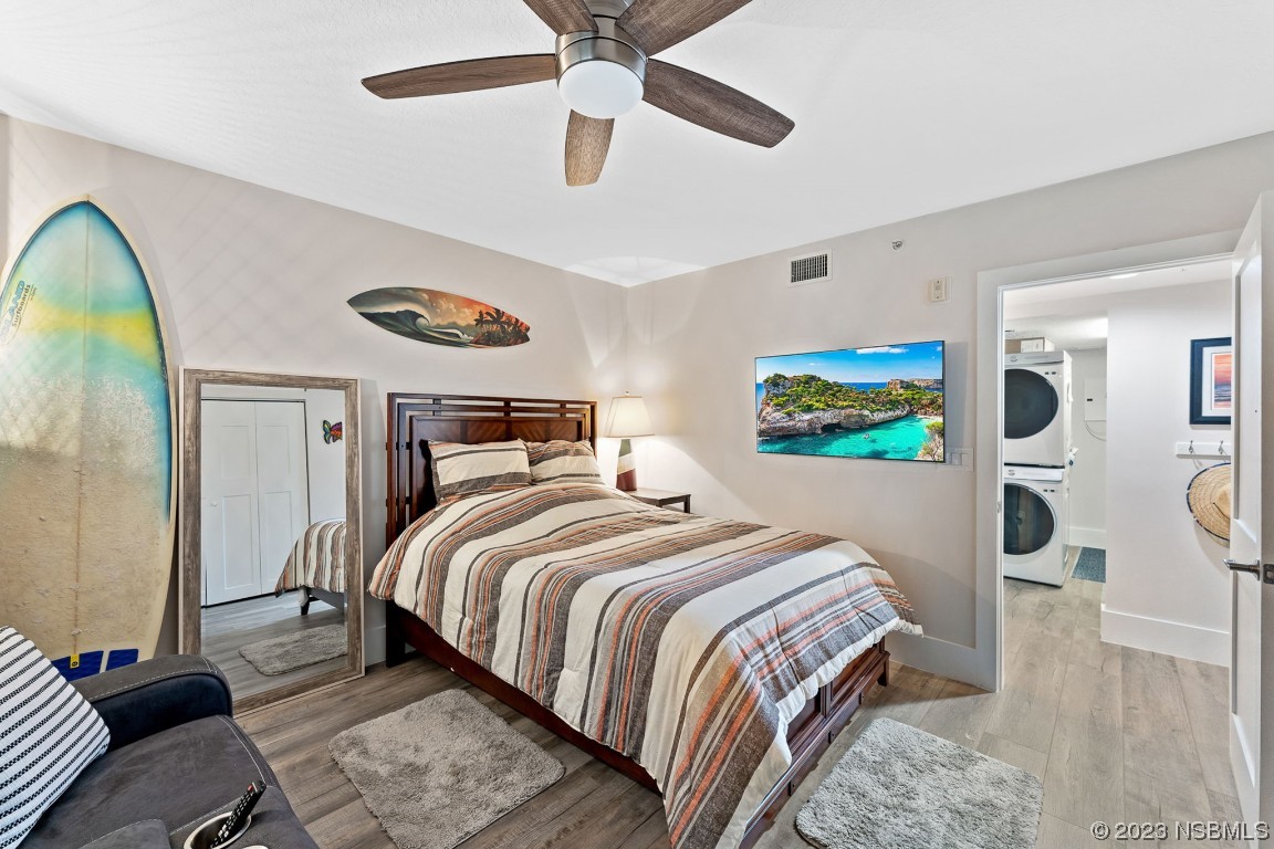4650 Links Village Drive, Unit A301 Ponce Inlet, FL 32127 - Photo 29 of 54 a bedroom with a bed and wooden floor