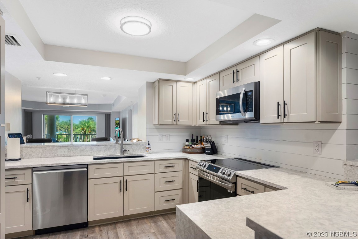 4650 Links Village Drive, Unit A301 Ponce Inlet, FL 32127 - Photo 3 of 54 a kitchen with a sink stove top oven and refrigerator