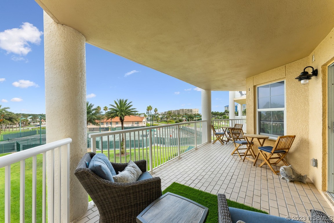 4650 Links Village Drive, Unit A301 Ponce Inlet, FL 32127 - Photo 31 of 54 a balcony with furniture and a potted plant