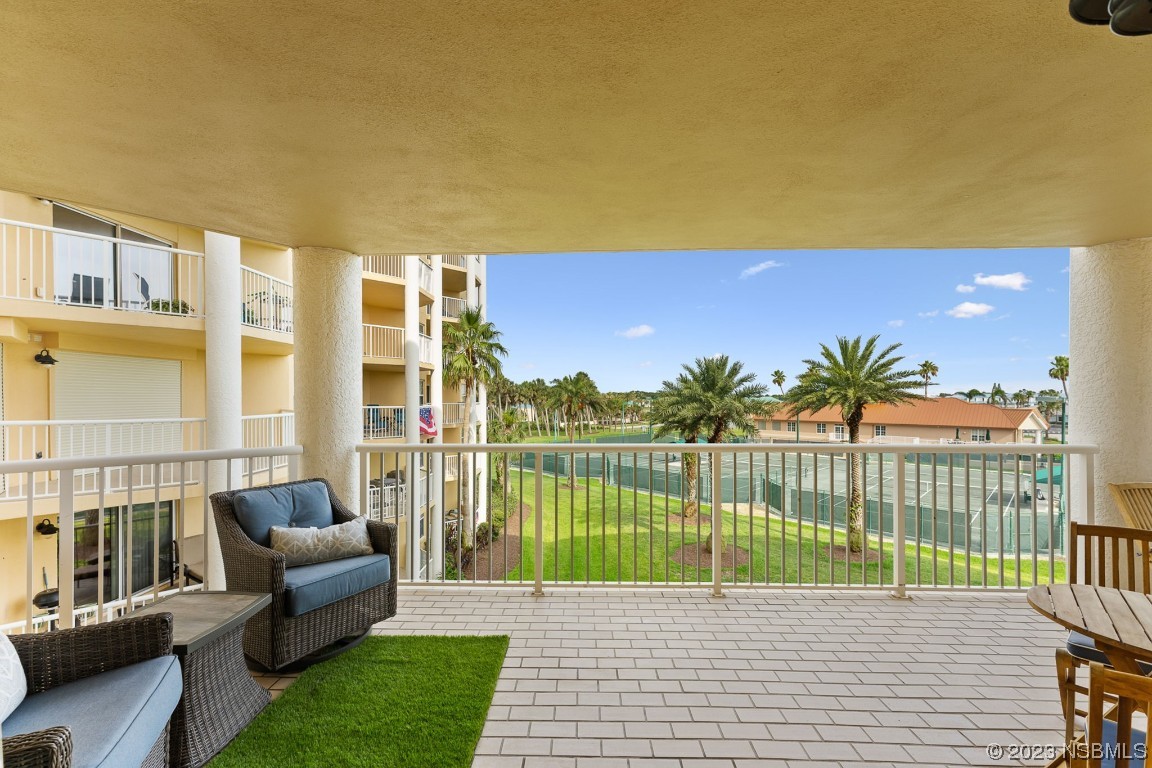 4650 Links Village Drive, Unit A301 Ponce Inlet, FL 32127 - Photo 32 of 54 a view of a terrace with couches and city view