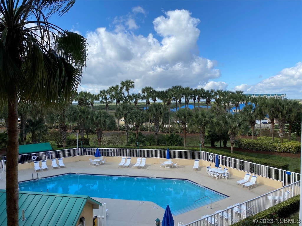 4650 Links Village Drive, Unit A301 Ponce Inlet, FL 32127 - Photo 37 of 54 a view of a swimming pool with a patio