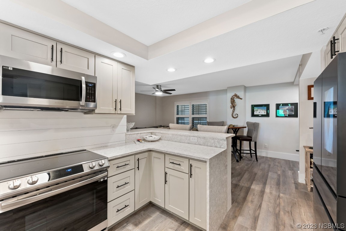 4650 Links Village Drive, Unit A301 Ponce Inlet, FL 32127 - Photo 4 of 54 a kitchen with a sink stove and microwave