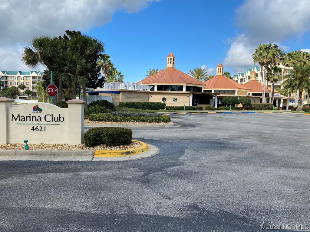 4650 Links Village Drive, Unit A301 Ponce Inlet, FL 32127 - Photo 44 of 54 a front view of a house with a yard and garage