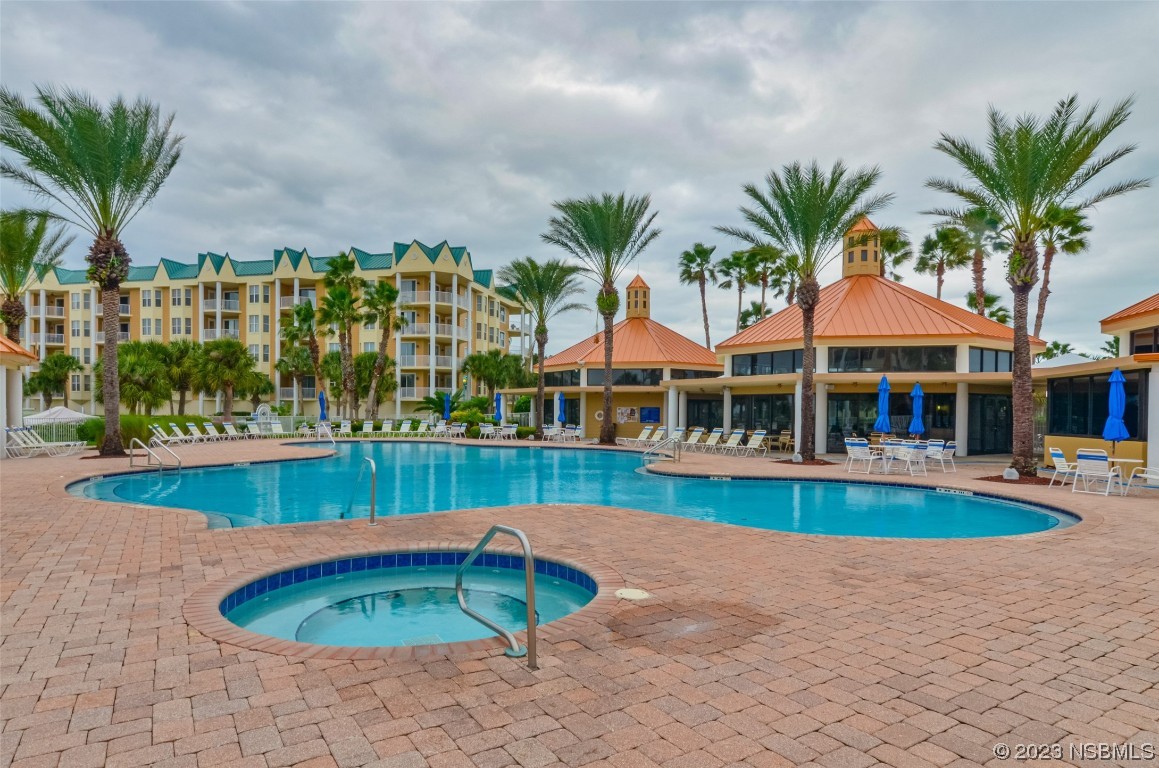 4650 Links Village Drive, Unit A301 Ponce Inlet, FL 32127 - Photo 46 of 54 a view of swimming pool with outdoor seating and plants