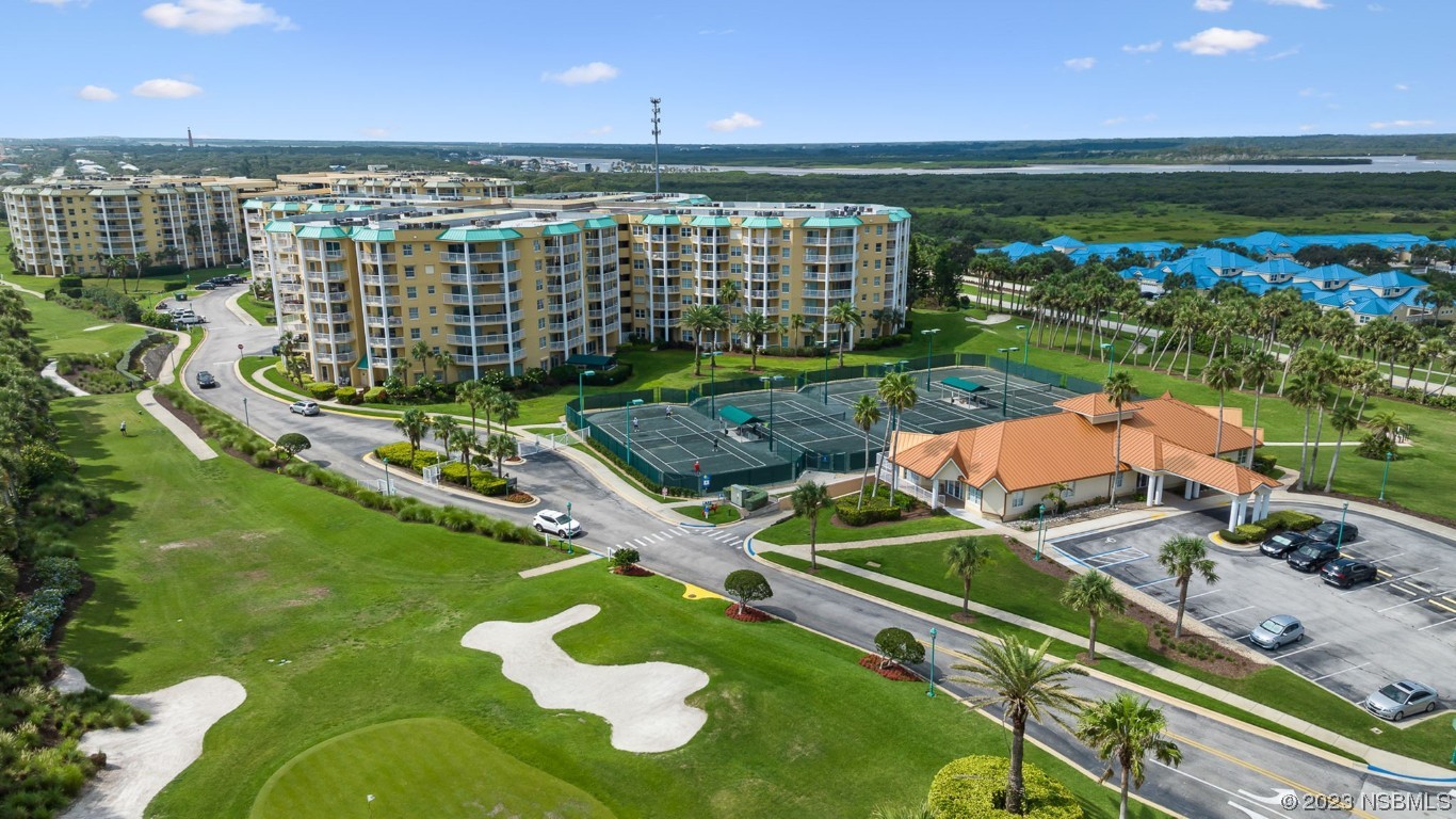 4650 Links Village Drive, Unit A301 Ponce Inlet, FL 32127 - Photo 51 of 54 an aerial view of a house with a garden and lake view