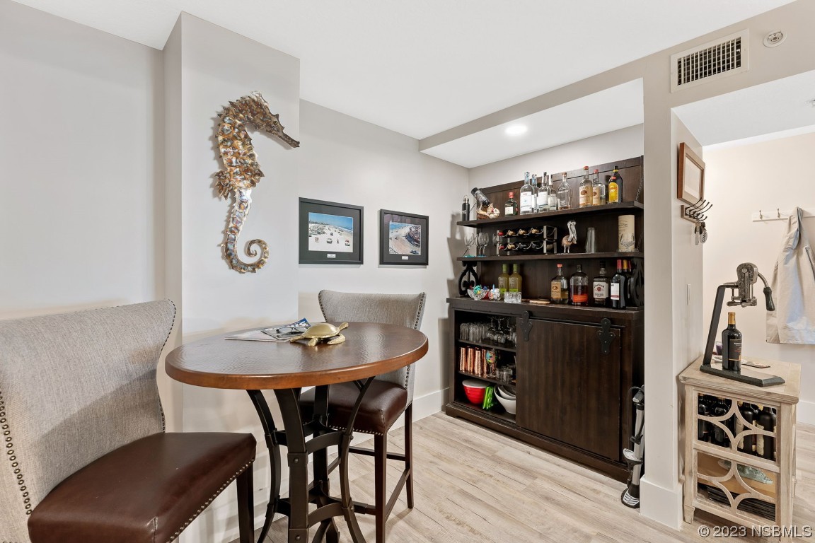 4650 Links Village Drive, Unit A301 Ponce Inlet, FL 32127 - Photo 7 of 54 a dining room with furniture and wooden floor