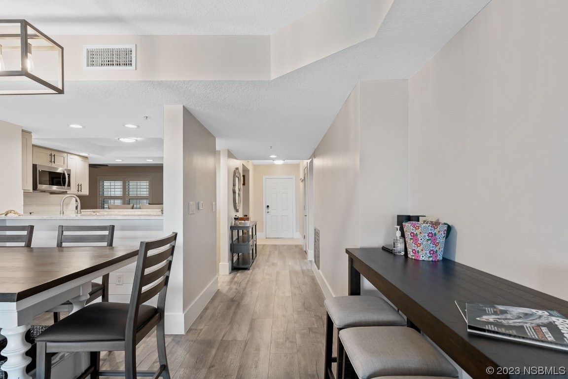 4650 Links Village Drive, Unit A301 Ponce Inlet, FL 32127 - Photo 9 of 54 a living room with furniture and a table