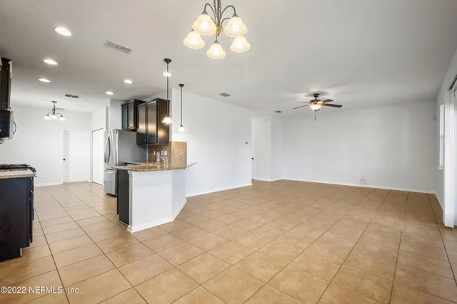 a kitchen with stainless steel appliances granite countertop a sink a stove and a refrigerator