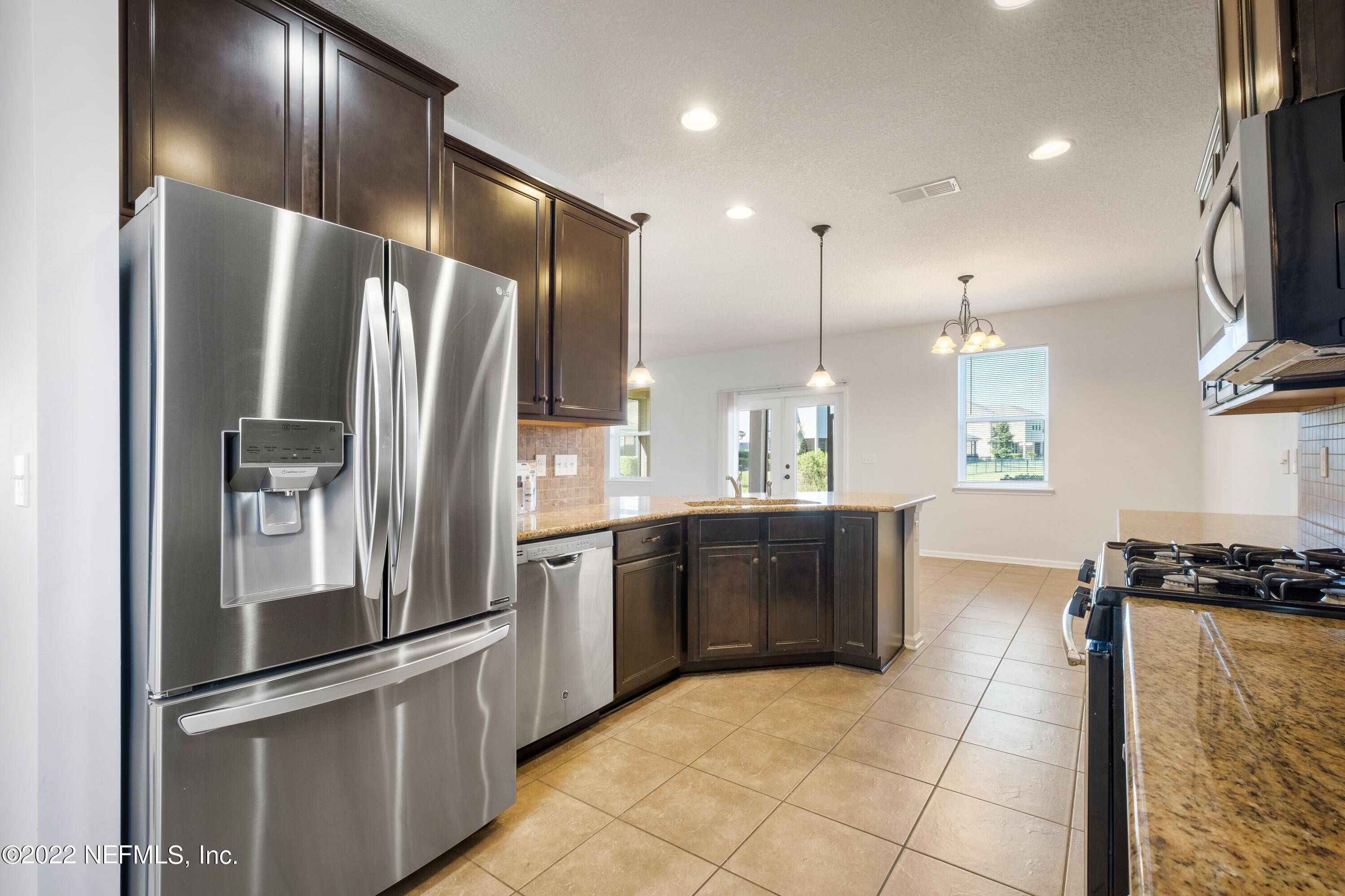 157 Heron Landing Road St. Johns, FL 32259 - Photo 16 of 40 a kitchen with stainless steel appliances granite countertop a refrigerator and a sink