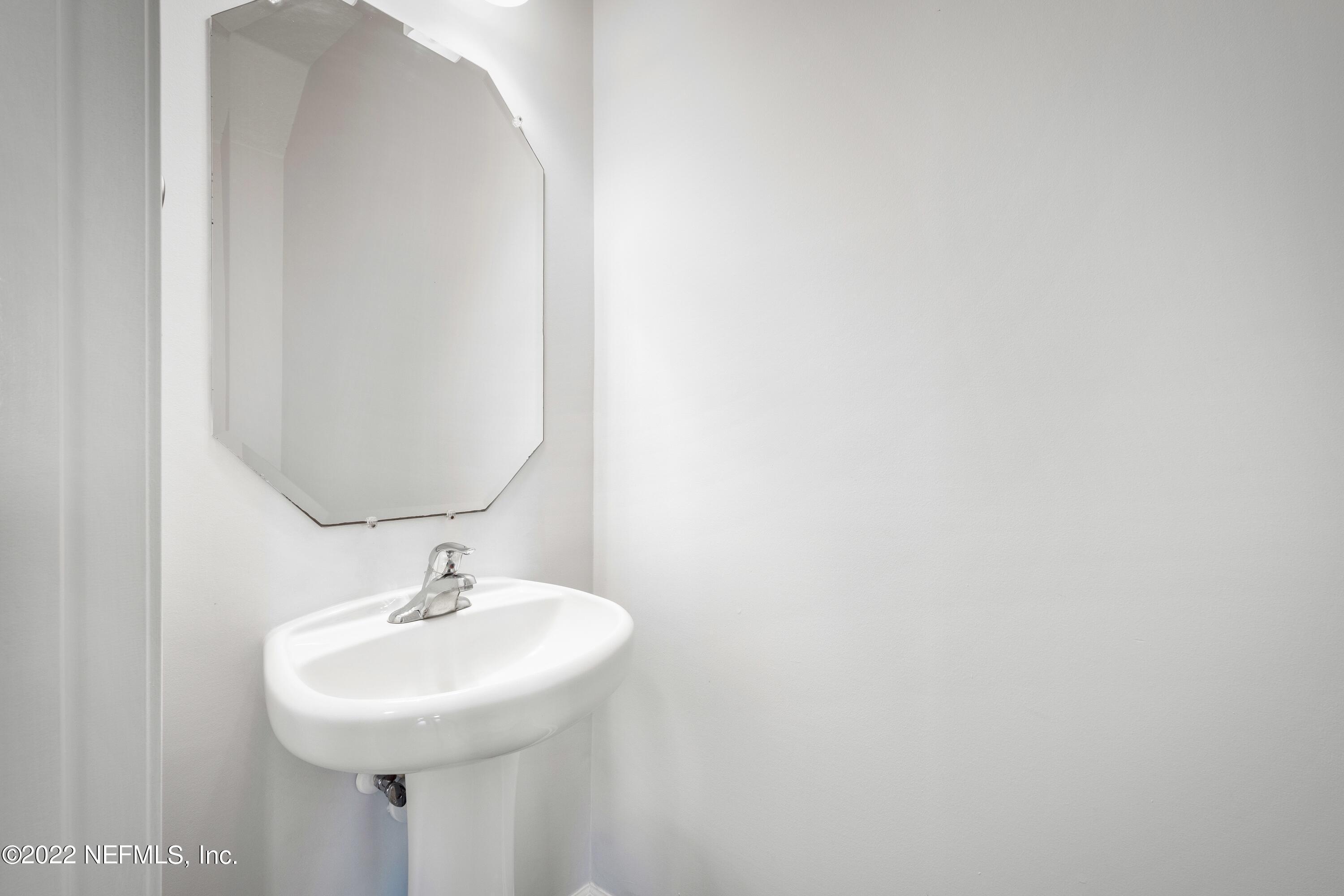 157 Heron Landing Road St. Johns, FL 32259 - Photo 19 of 40 a bathroom with a sink and a mirror