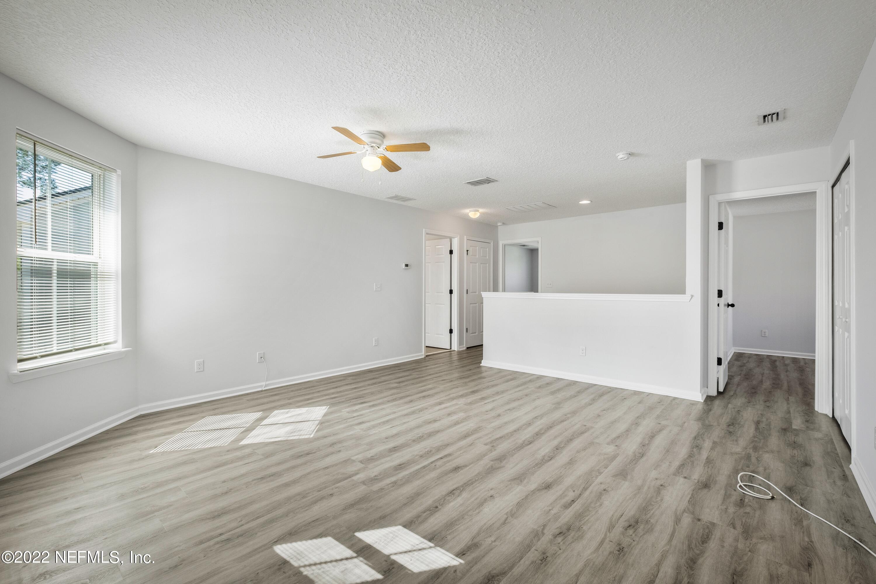 157 Heron Landing Road St. Johns, FL 32259 - Photo 20 of 40 wooden floor in an empty room with a window