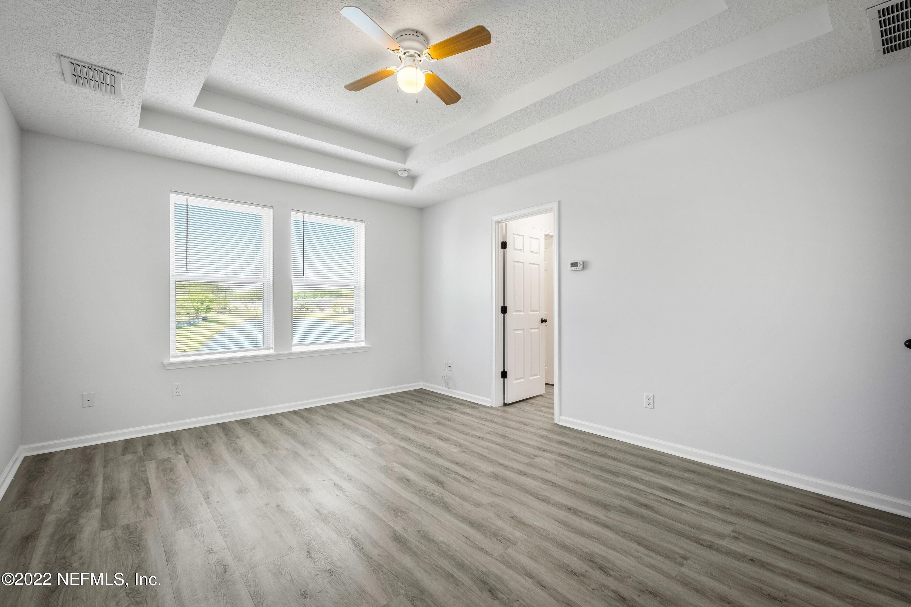 157 Heron Landing Road St. Johns, FL 32259 - Photo 23 of 40 wooden floor in an empty room with a window