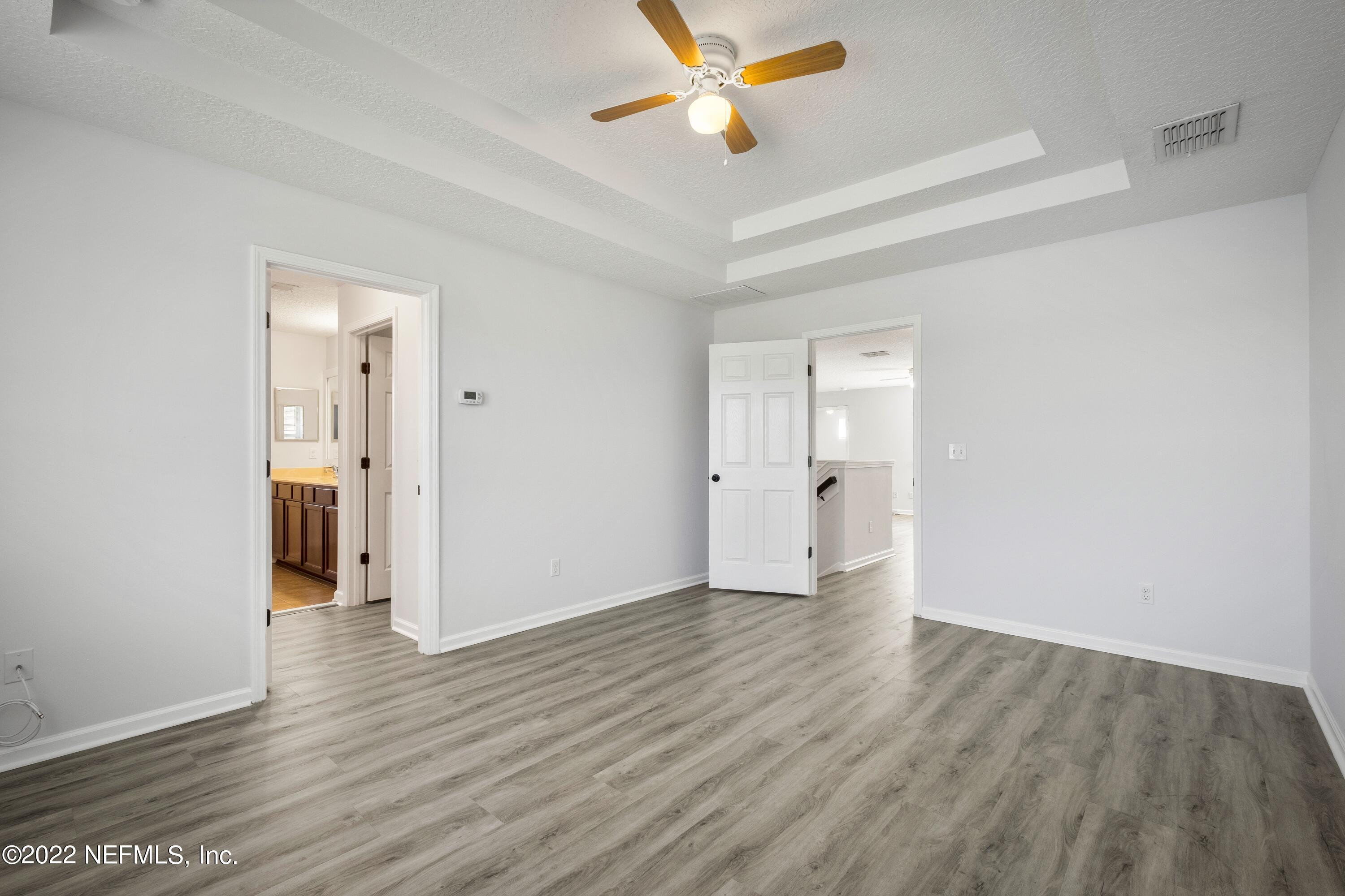 157 Heron Landing Road St. Johns, FL 32259 - Photo 25 of 40 a view of an empty room and window and wooden floor