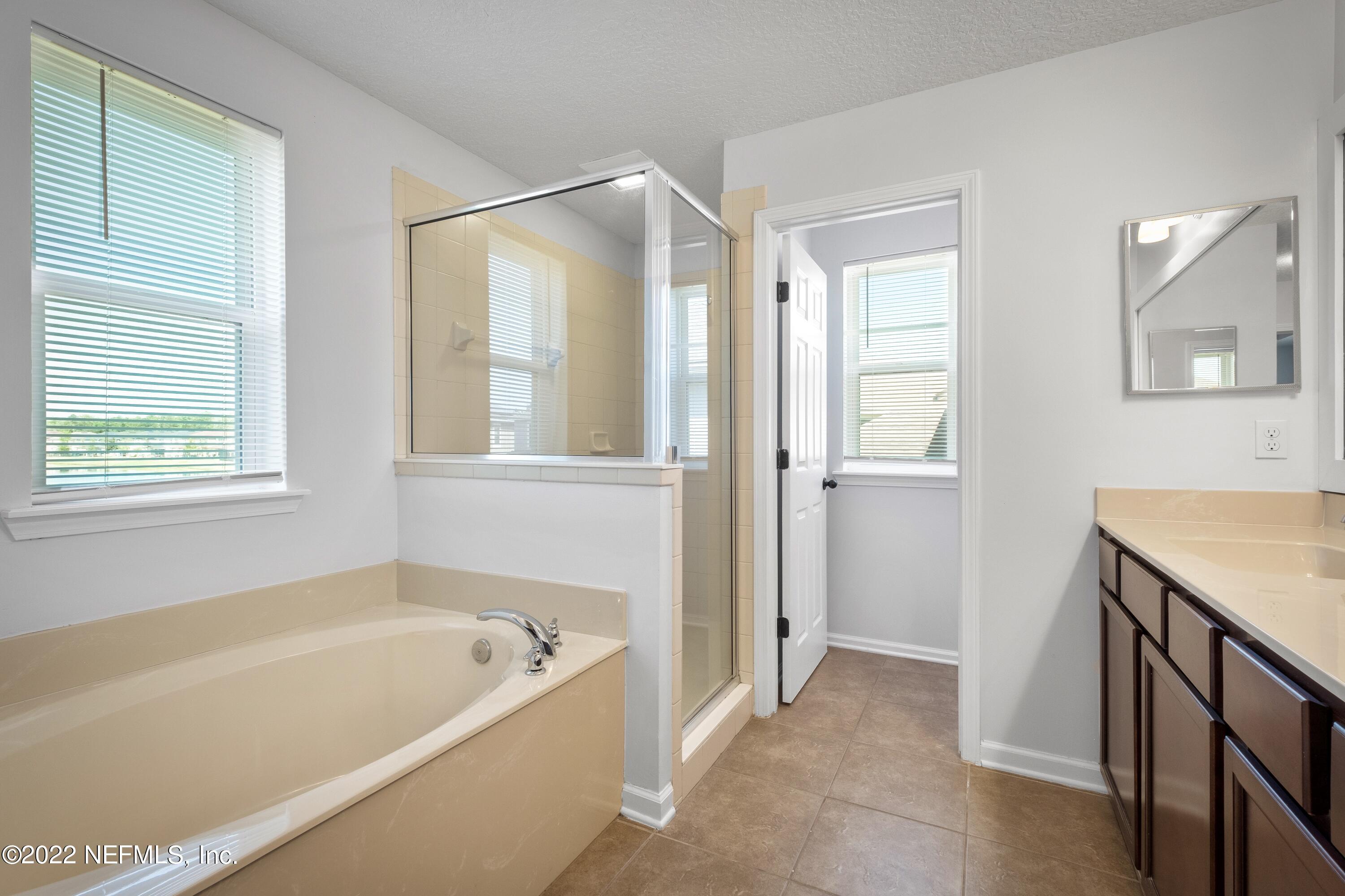 157 Heron Landing Road St. Johns, FL 32259 - Photo 26 of 40 a bathroom with a bathtub and a shower