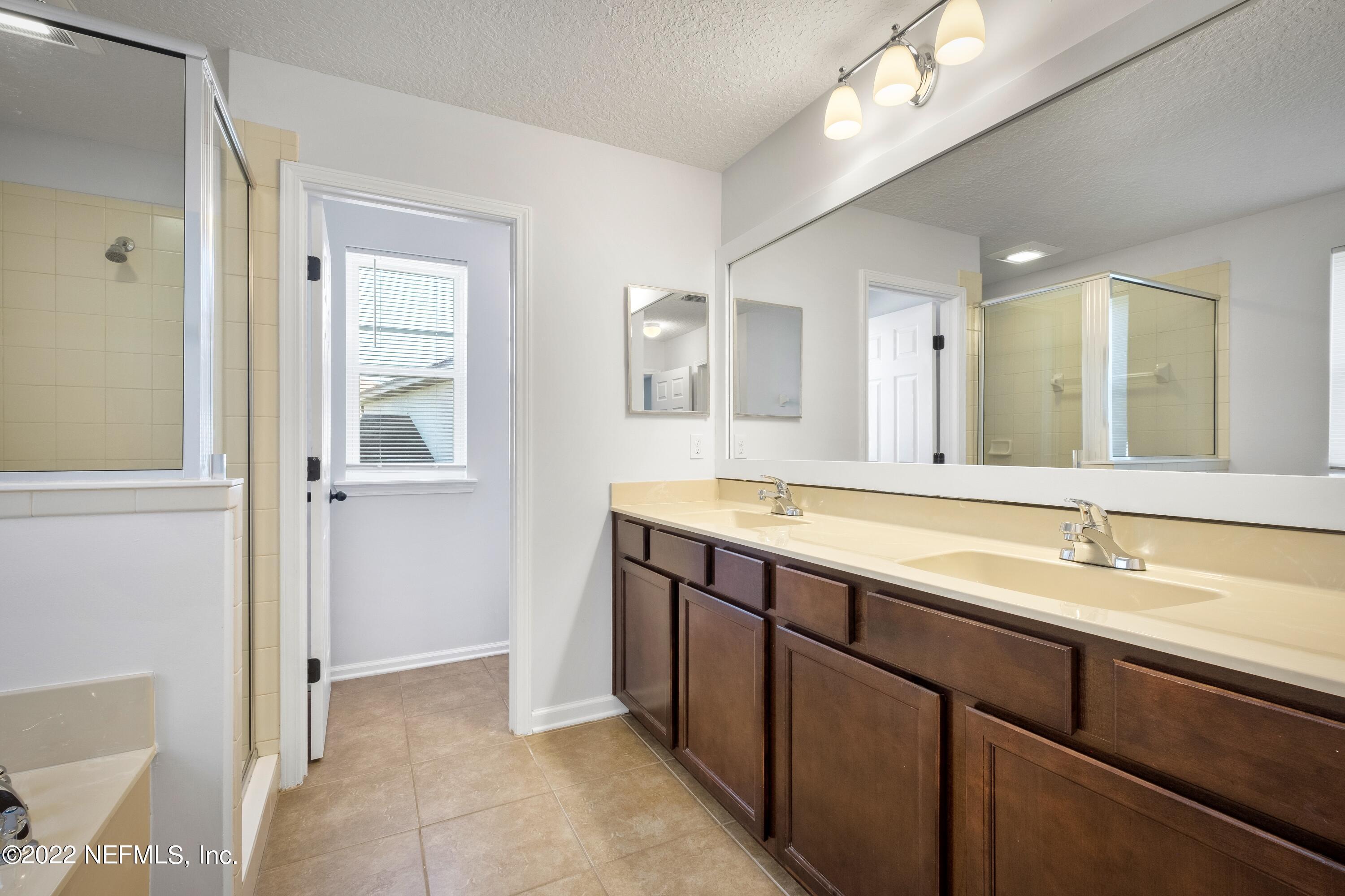 157 Heron Landing Road St. Johns, FL 32259 - Photo 27 of 40 a spacious bathroom with a double vanity sink a mirror and a shower