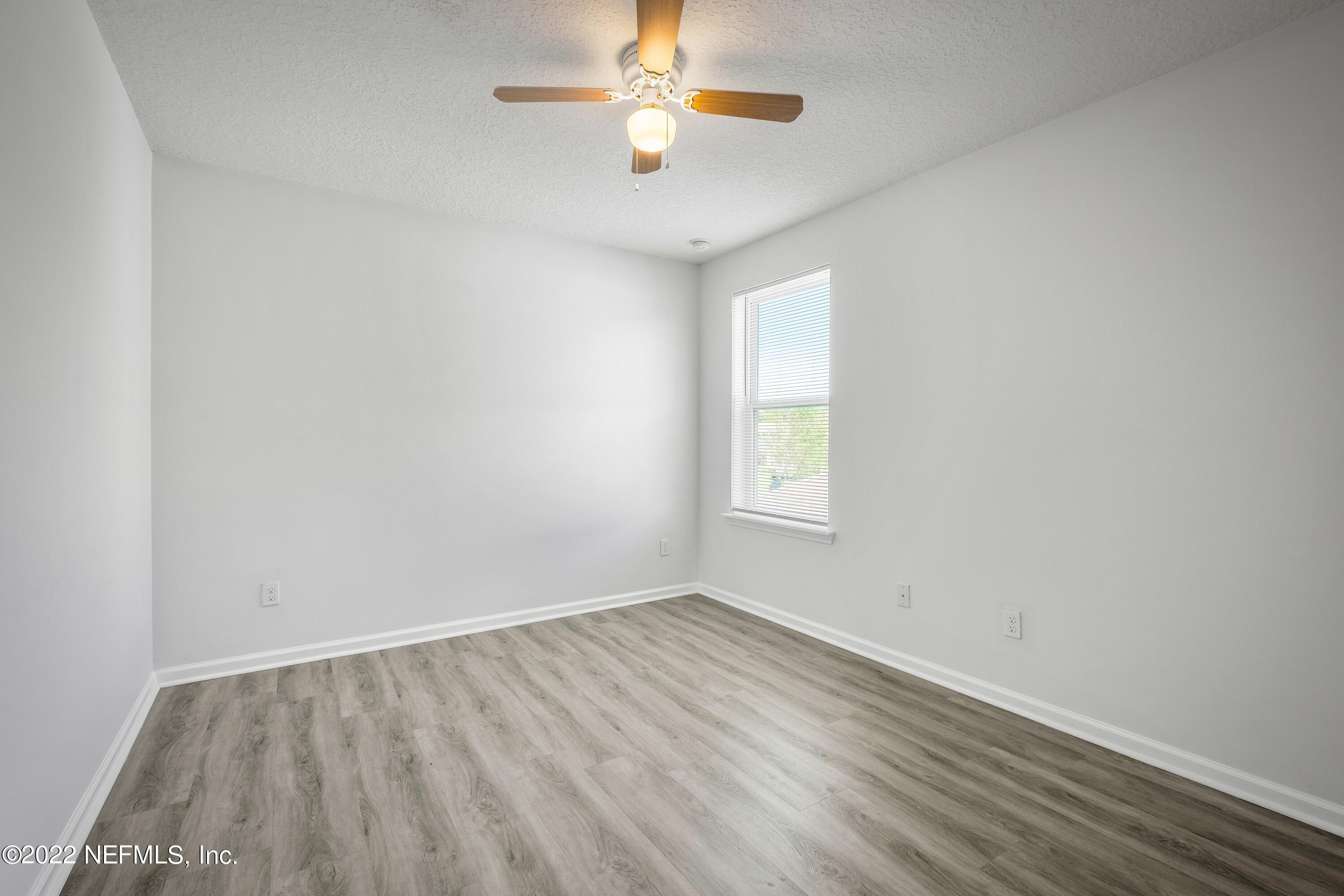 157 Heron Landing Road St. Johns, FL 32259 - Photo 29 of 40 an empty room with a window and a ceiling fan