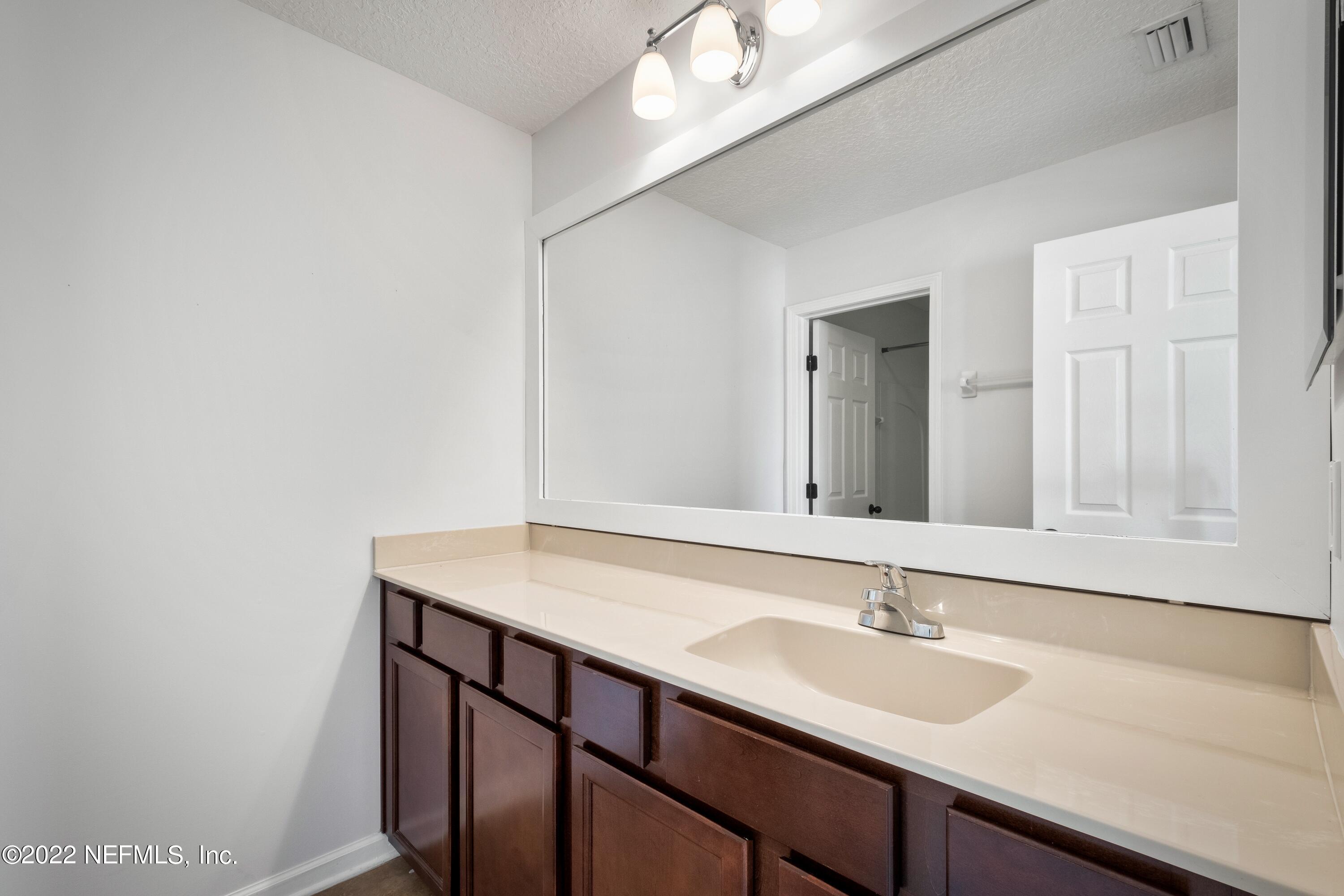 157 Heron Landing Road St. Johns, FL 32259 - Photo 30 of 40 a bathroom with a sink and a mirror