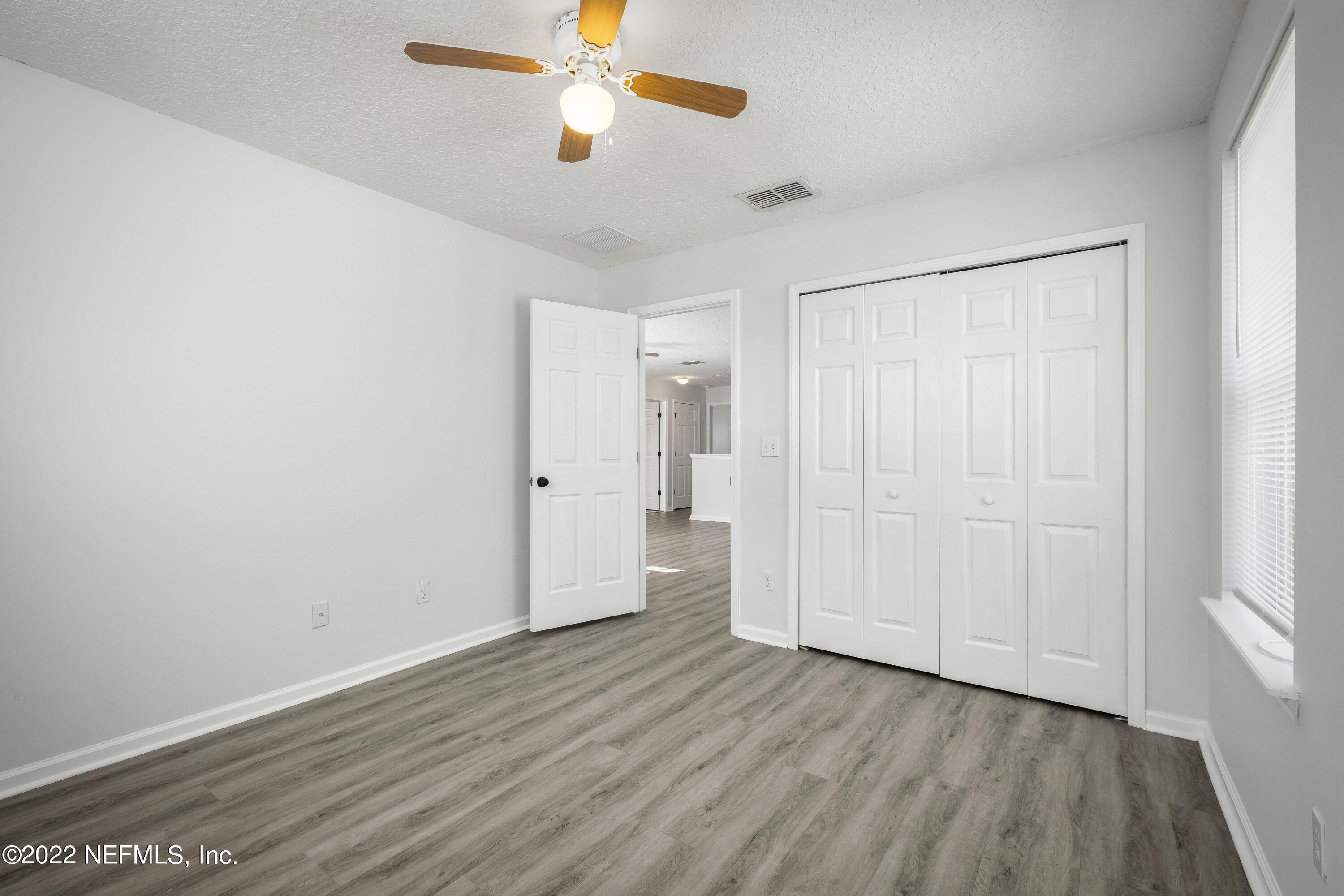 157 Heron Landing Road St. Johns, FL 32259 - Photo 32 of 40 wooden floor in an empty room with a window