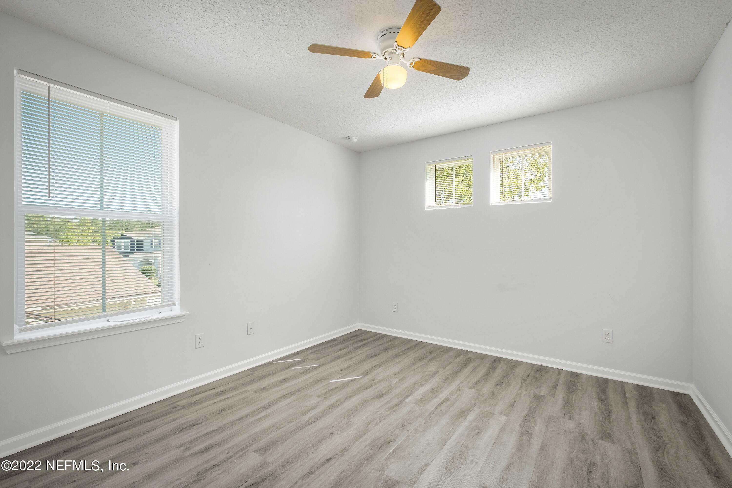 157 Heron Landing Road St. Johns, FL 32259 - Photo 33 of 40 an empty room with a window and a ceiling fan