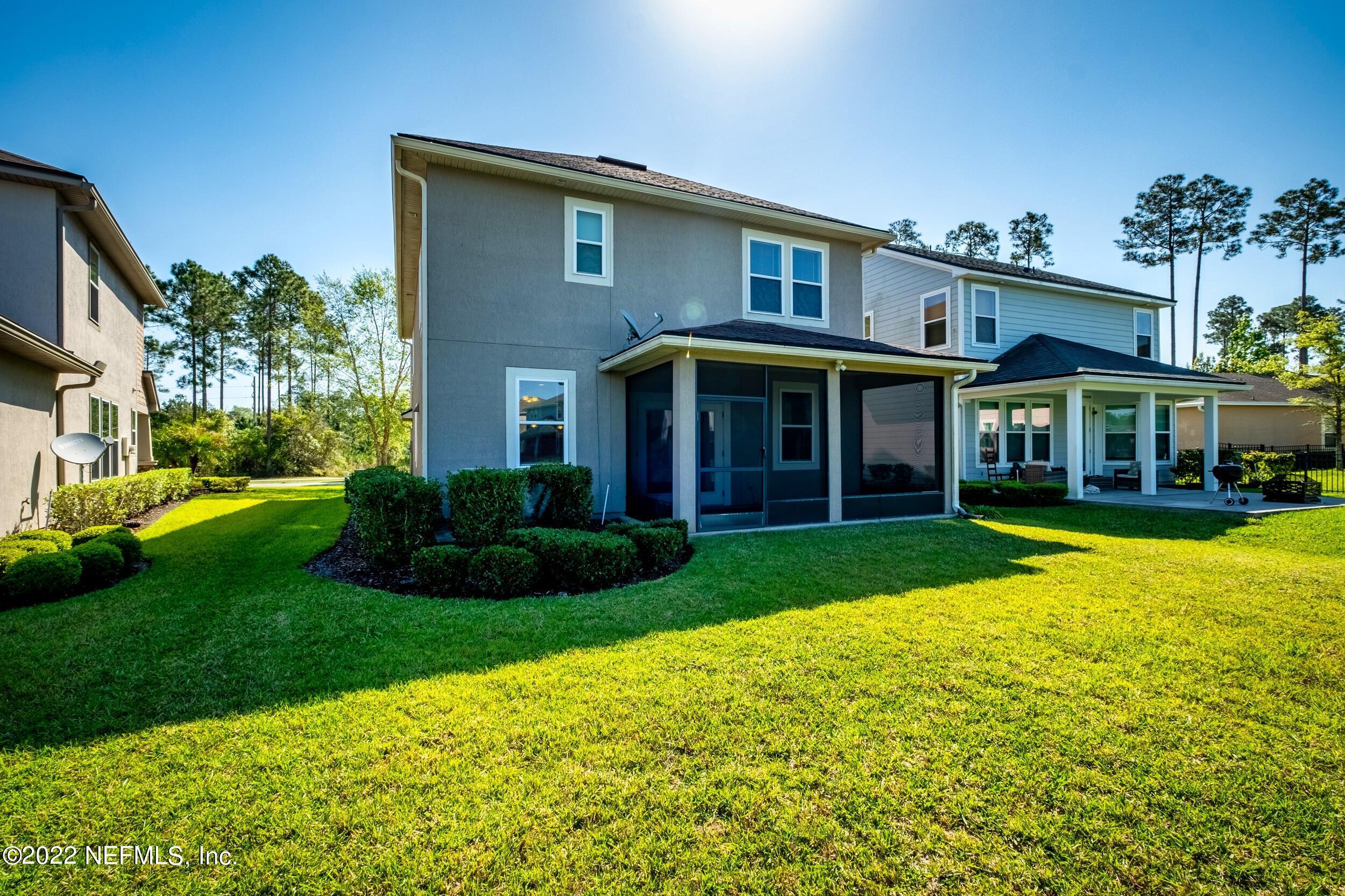 157 Heron Landing Road St. Johns, FL 32259 - Photo 37 of 40 a view of a house with a yard potted plants and a table