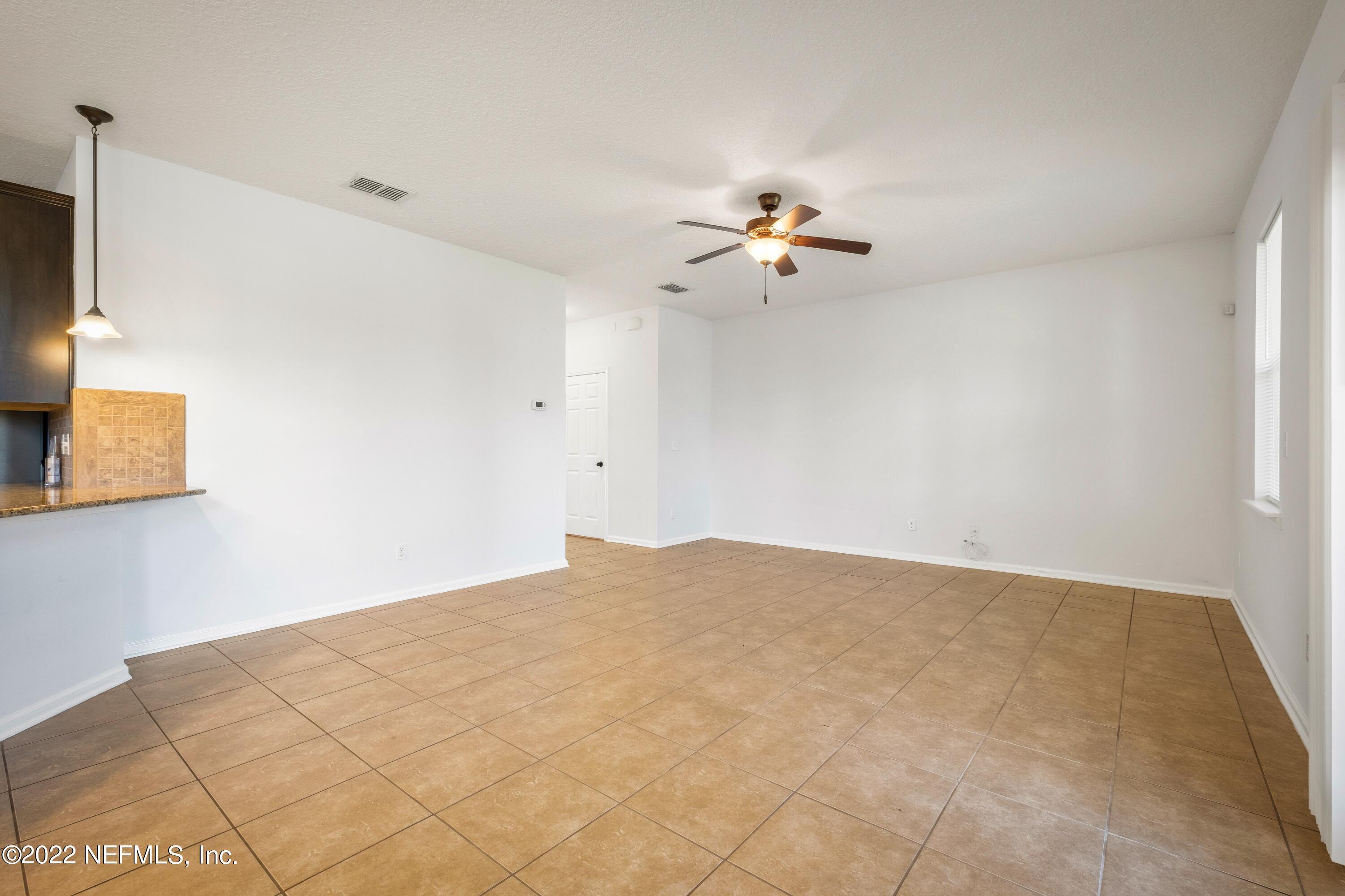 157 Heron Landing Road St. Johns, FL 32259 - Photo 10 of 40 a view of a big room with a ceiling fan and a window