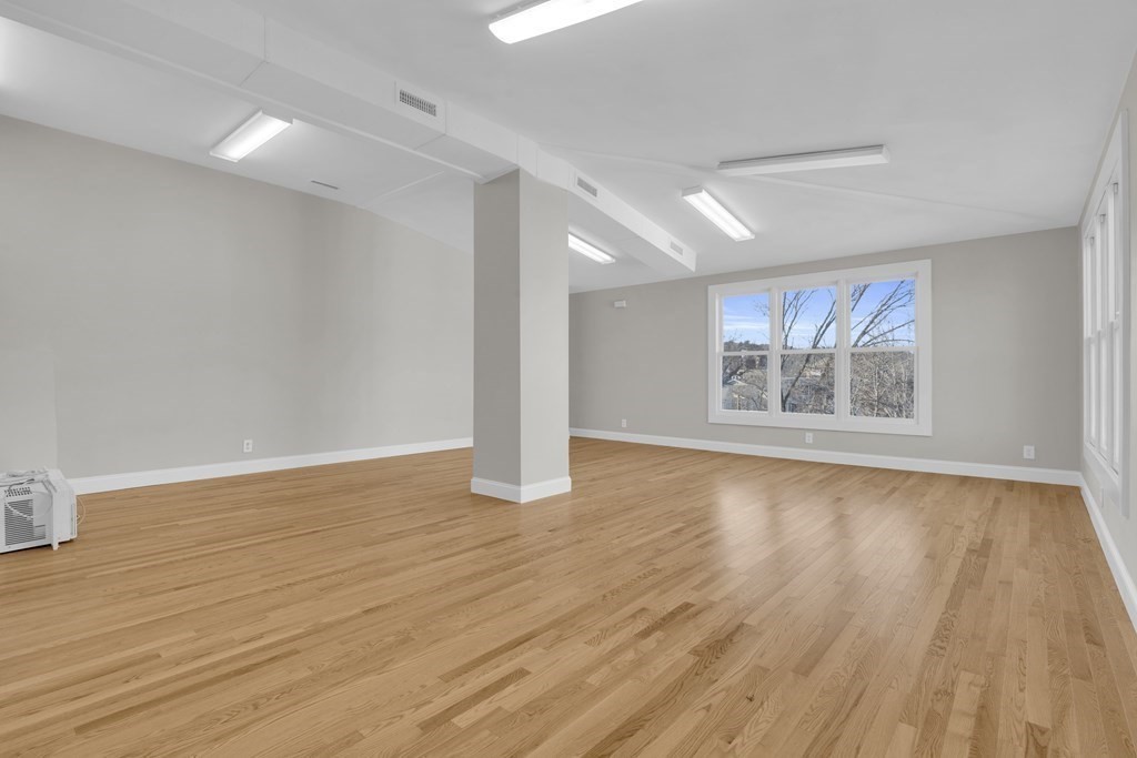 201 High Street, Unit 3 Brookline, MA 02445 - Photo 1 of 14 a view of an empty room with wooden floor and a window