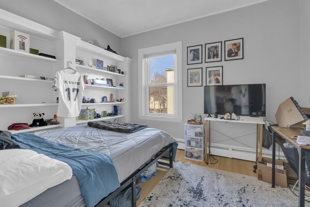 201 High Street, Unit 3 Brookline, MA 02445 - Photo 11 of 14 a bedroom that has a bed and a desk in it
