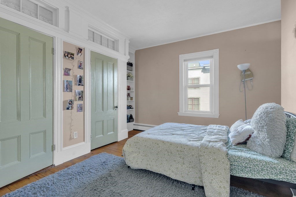 201 High Street, Unit 3 Brookline, MA 02445 - Photo 13 of 14 a bedroom with a bed and a window