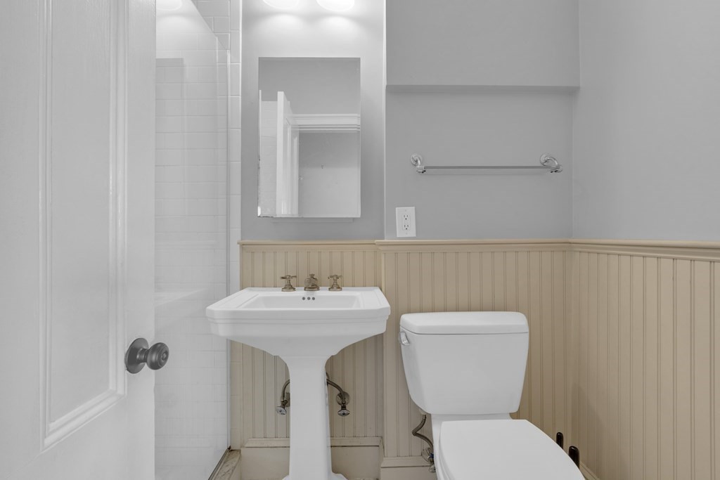 201 High Street, Unit 3 Brookline, MA 02445 - Photo 8 of 14 a bathroom with a toilet sink and mirror