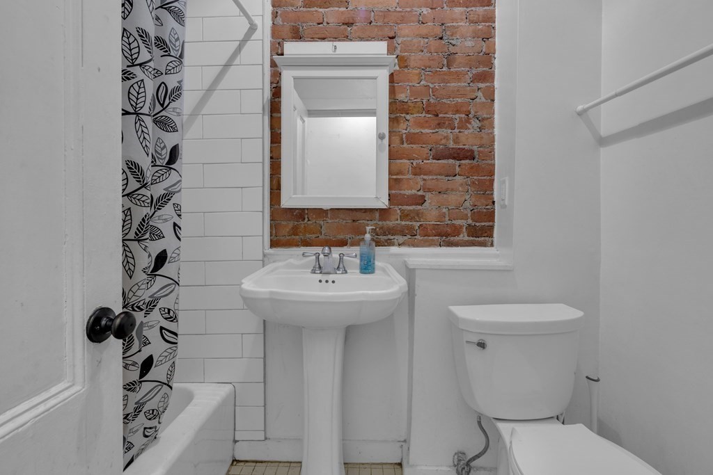 201 High Street, Unit 3 Brookline, MA 02445 - Photo 10 of 14 a bathroom with a sink a toilet and shower