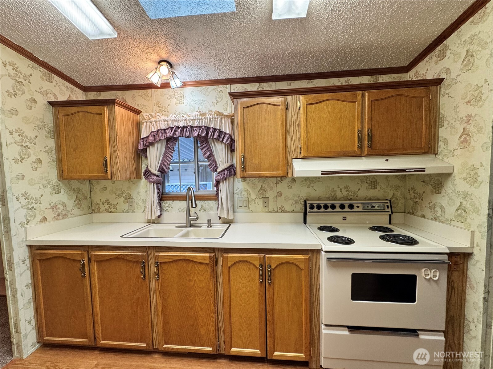 2388 Sparrow Loop, Unit 155 Kelso, WA 98626 - Photo 6 of 22 a kitchen with granite countertop a sink stainless steel appliances and cabinets
