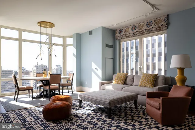 a living room with furniture a window and a chandelier
