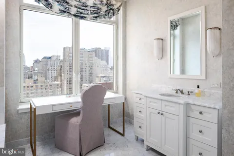 a bathroom with a double vanity sink and a window