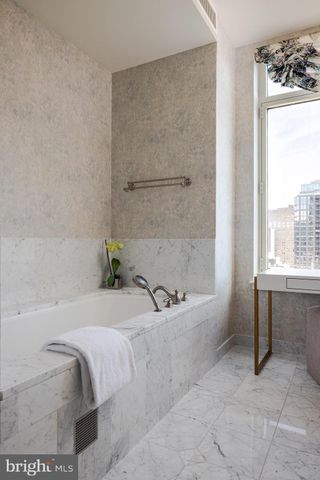 a bath tub sitting next to a window