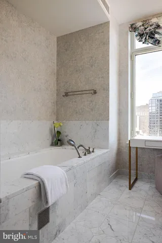 a bath tub sitting next to a window