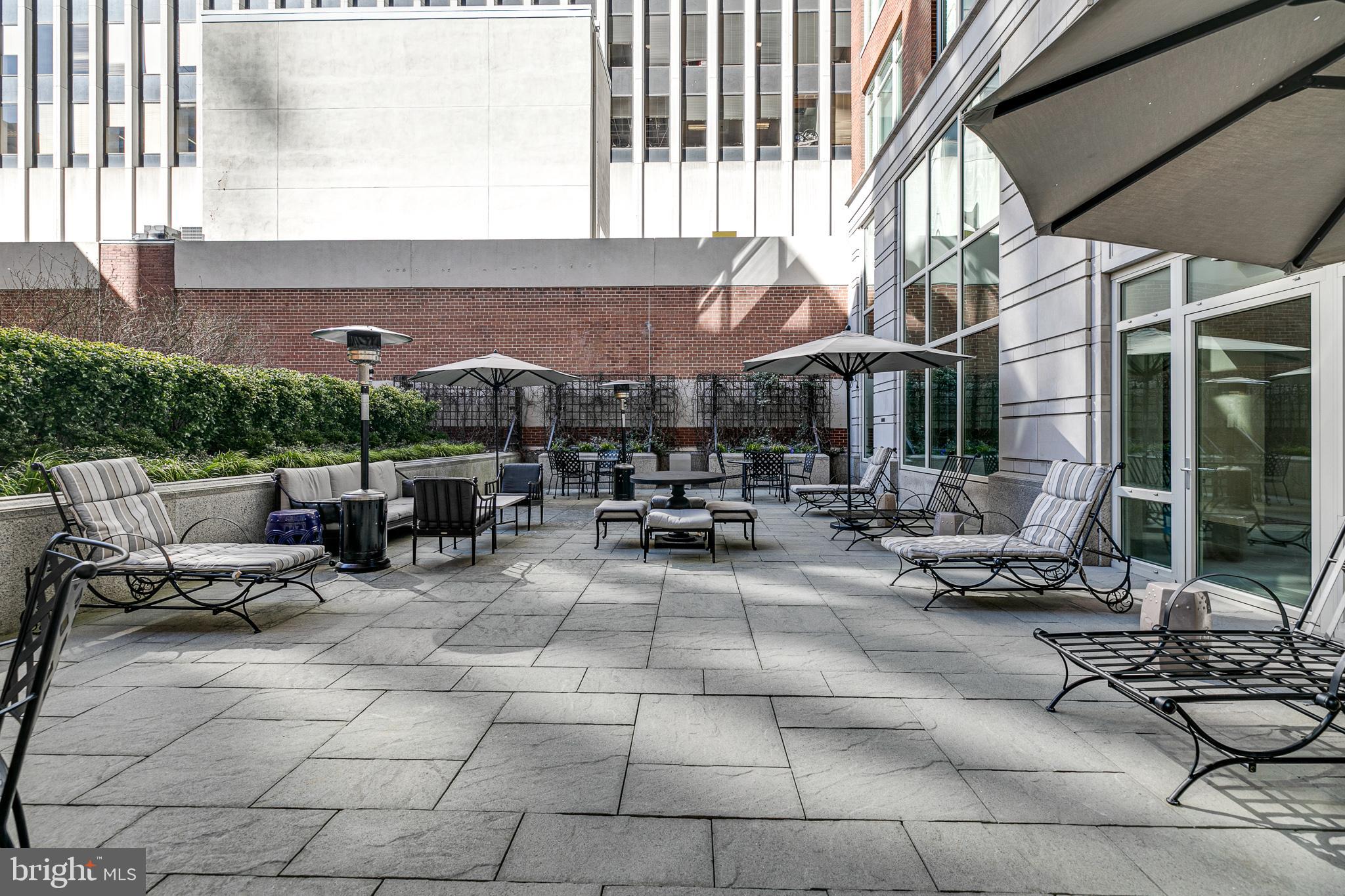 130 South 18th Street, Unit 1804 Philadelphia, PA 19103 - Photo 33 of 36 a view of a patio with table and chairs and floor to ceiling window