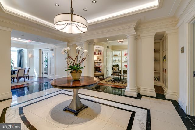 a living room with fireplace furniture and a chandelier