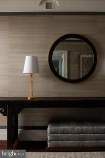 a living room with furniture and a lamp