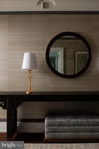 a living room with furniture and a lamp