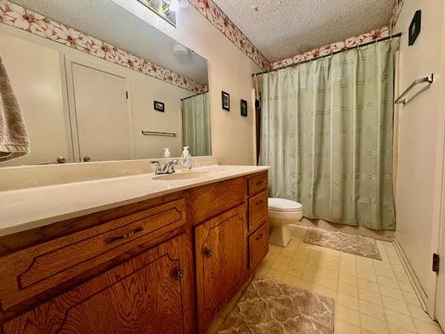 a spacious bathroom with a double vanity sink mirror and toilet