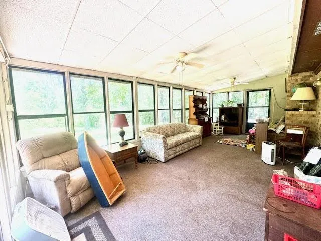 a bedroom with furniture and a large window