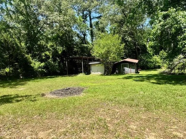 a swimming pool with trees in the background