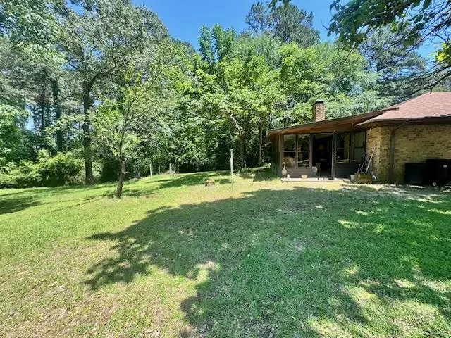 a backyard of a house with yard and trampoline