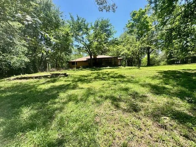 a backyard of a house with lots of green space